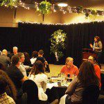 Event presentation with Amber Effect Events at the podium and guests seated at tables: Event Management, Food Tasting, Wine Tasting, Beer Festivals, Corporate Events. Moncton, Dieppe, Fredericton, Saint John, Halifax, Summerside, Shediac, Sussex, Bouctouche, Sackville, Miramichi